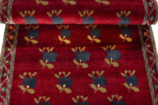 Full view of 2000s Persian Gabbeh rug from Iran / Persia, 200 × 86 cm in Red tones