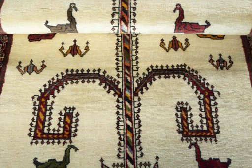 Corner detail of 2000s Persian Gabbeh rug showing border pattern and Wool pile