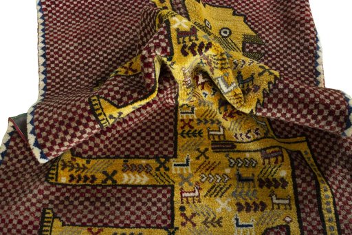 Corner detail of 2000s Persian Gabbeh rug showing border pattern and Wool pile