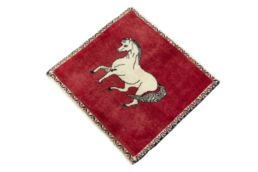 Corner detail of 2000s Persian Gabbeh rug showing border pattern and Wool pile