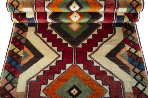 Corner detail of 2000s Persian Gabbeh rug showing border pattern and Wool pile