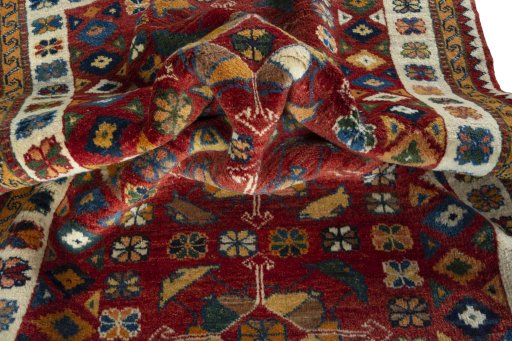 Corner detail of 2000s Persian Gabbeh rug showing border pattern and Wool pile
