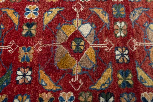 Backside of handmade 2000s Persian Gabbeh rug showing knot structure and weave density