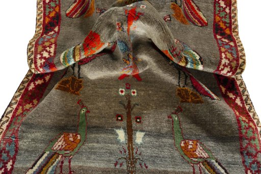 Corner detail of 2000s Persian Gabbeh rug showing border pattern and Wool pile