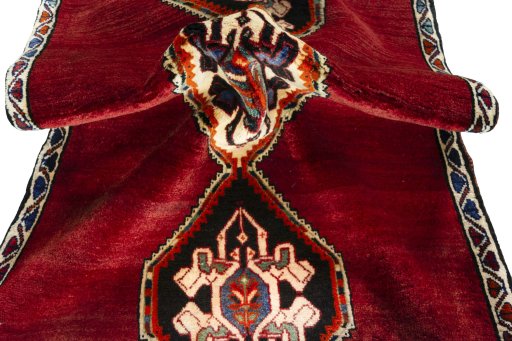 Corner detail of 2000s Persian Gabbeh rug showing border pattern and Wool pile