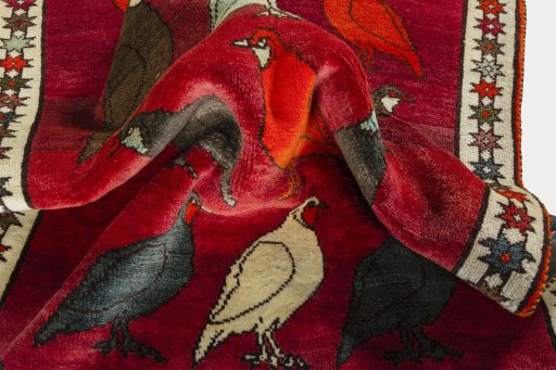 Corner detail of 2000s Persian Gabbeh rug showing border pattern and Wool pile