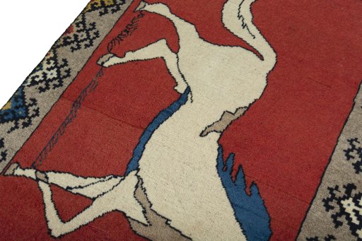 Backside of handmade 2000s Persian Gabbeh rug showing knot structure and weave density