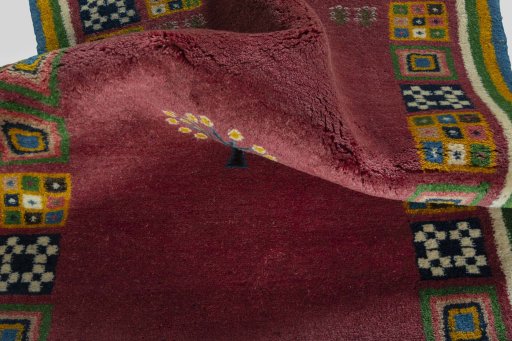 Corner detail of New Persian Gabbeh rug showing border pattern and Wool pile