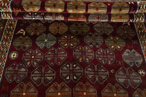 Full view of 2000s Persian Gabbeh rug from Iran / Persia, 286 × 162 cm in Red tones
