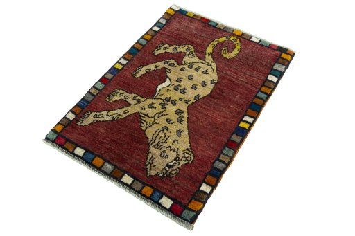 Corner detail of 2000s Persian Gabbeh rug showing border pattern and Wool pile