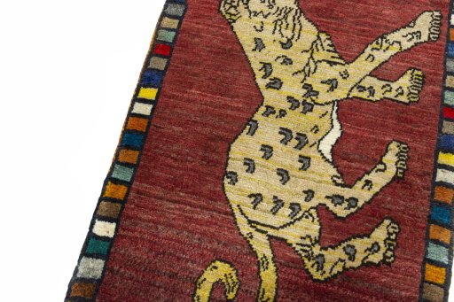 Backside of handmade 2000s Persian Gabbeh rug showing knot structure and weave density