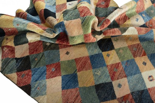 Corner detail of 2000s Persian Gabbeh rug showing border pattern and Wool pile