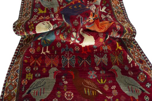 Corner detail of 2000s Persian Gabbeh rug showing border pattern and Wool pile