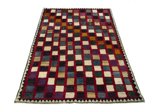 Surface texture of 2000s Persian Gabbeh rug with natural Wool and intricate pattern