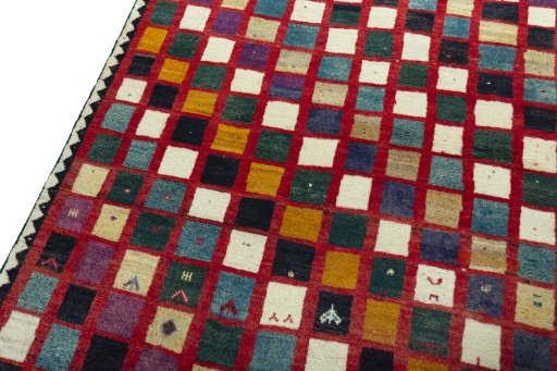 Backside of handmade 2000s Persian Gabbeh rug showing knot structure and weave density