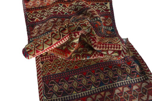 Corner detail of 2000s Persian Gabbeh rug showing border pattern and Wool pile