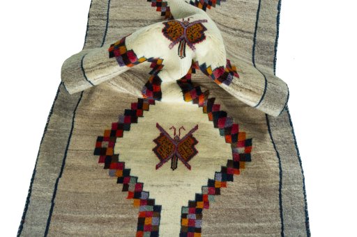 Corner detail of 2000s Persian Gabbeh rug showing border pattern and Wool pile