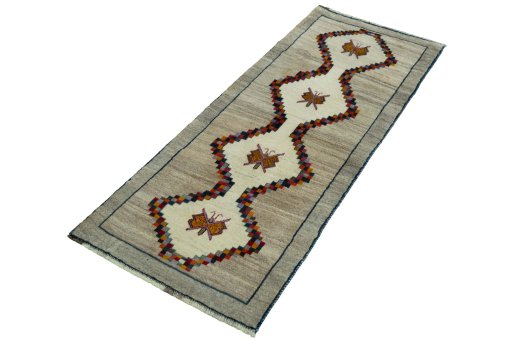 Corner detail of 2000s Persian Gabbeh rug showing border pattern and Wool pile