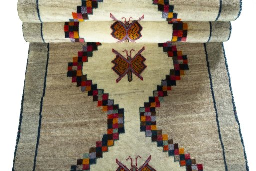 Full view of 2000s Persian Gabbeh rug from Iran / Persia, 209 × 82 cm in Beige tones
