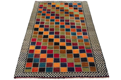 Surface texture of 2000s Persian Gabbeh rug with natural Wool and intricate pattern