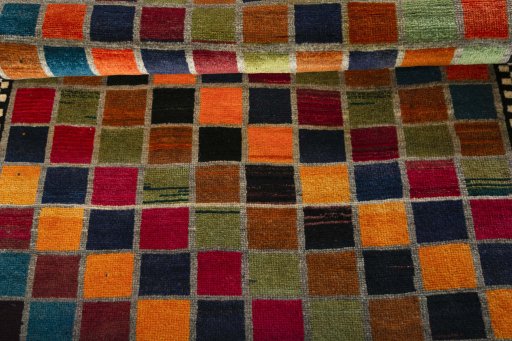 Full view of 2000s Persian Gabbeh rug from Iran / Persia, 210 × 131 cm in Multi Color tones