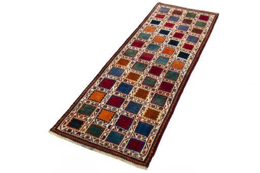 Corner detail of 2000s Persian Gabbeh rug showing border pattern and Wool pile