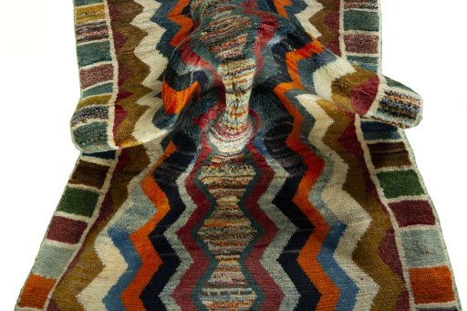 Corner detail of 2000s Persian Gabbeh rug showing border pattern and Wool pile