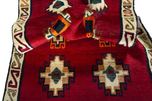 Corner detail of 2000s Persian Gabbeh rug showing border pattern and Wool pile