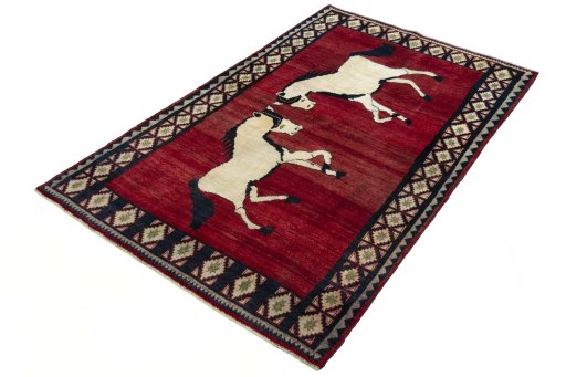 Corner detail of 2000s Persian Gabbeh rug showing border pattern and Wool pile