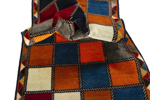 Corner detail of 2000s Persian Gabbeh rug showing border pattern and Wool pile