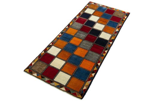 Corner detail of 2000s Persian Gabbeh rug showing border pattern and Wool pile