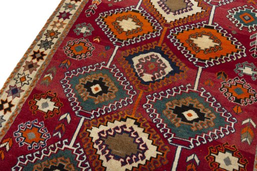Backside of handmade 2000s Persian Gabbeh rug showing knot structure and weave density