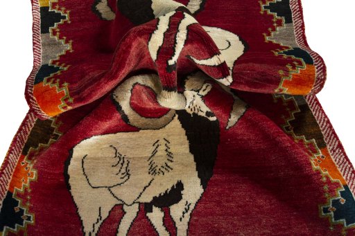Corner detail of 2000s Persian Gabbeh rug showing border pattern and Wool pile