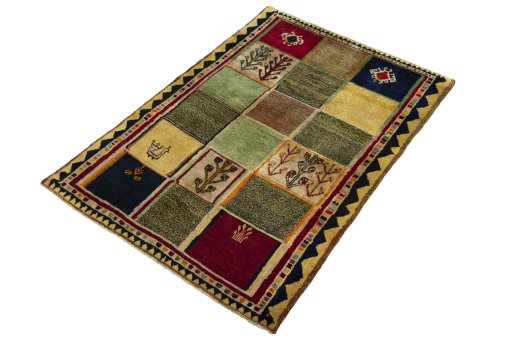 Corner detail of 2000s Persian Gabbeh rug showing border pattern and Wool pile