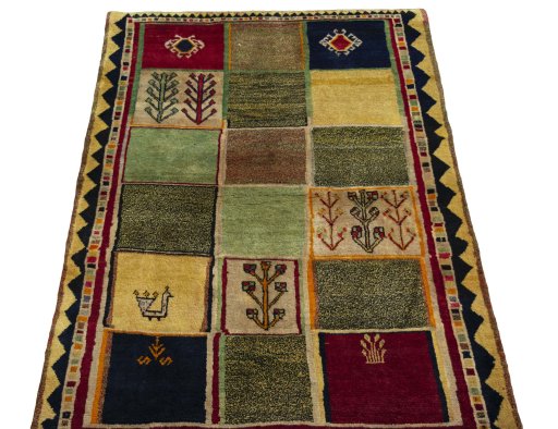 Surface texture of 2000s Persian Gabbeh rug with natural Wool and intricate pattern
