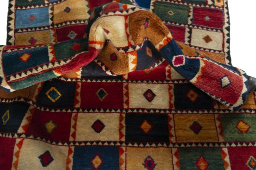Corner detail of 2000s Persian Gabbeh rug showing border pattern and Wool pile