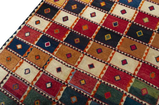 Backside of handmade 2000s Persian Gabbeh rug showing knot structure and weave density