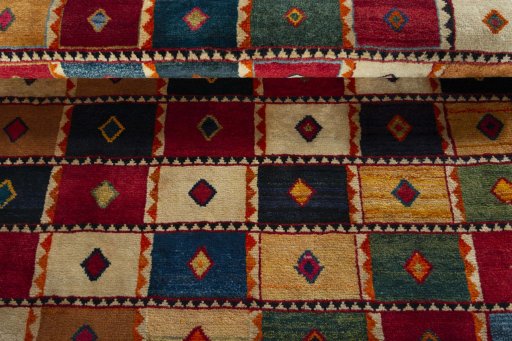 Full view of 2000s Persian Gabbeh rug from Iran / Persia, 171 × 127 cm in Multi Color tones