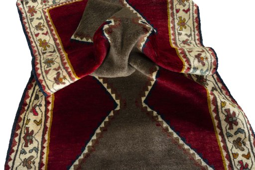 Corner detail of 2000s Persian Gabbeh rug showing border pattern and Wool pile
