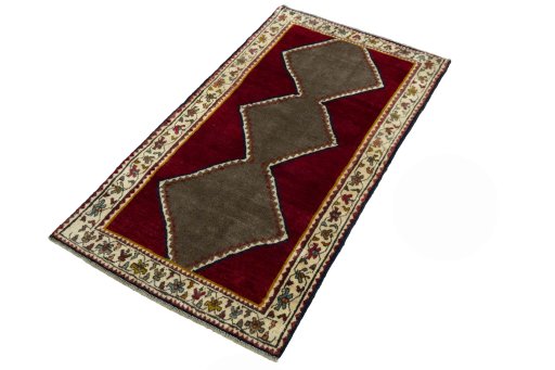 Corner detail of 2000s Persian Gabbeh rug showing border pattern and Wool pile