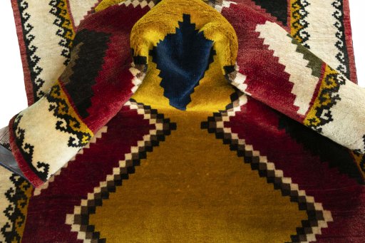 Corner detail of 2000s Persian Gabbeh rug showing border pattern and Wool pile