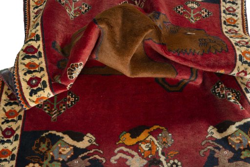 Corner detail of 2000s Persian Gabbeh rug showing border pattern and Wool pile