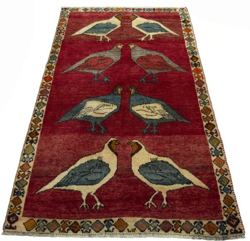 Surface texture of 2000s Persian Gabbeh rug with natural Wool and intricate pattern