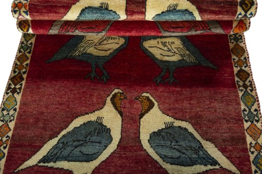 Full view of 2000s Persian Gabbeh rug from Iran / Persia, 186 × 98 cm in Red tones