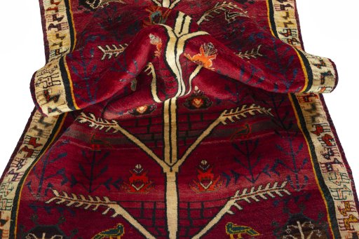 Corner detail of 2000s Persian Gabbeh rug showing border pattern and Wool pile
