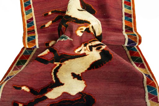 Corner detail of 2000s Persian Gabbeh rug showing border pattern and Wool pile