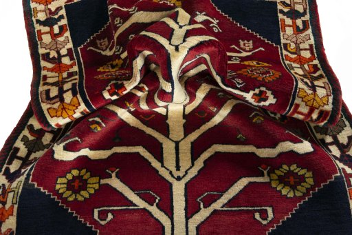 Corner detail of 2000s Persian Gabbeh rug showing border pattern and Wool pile