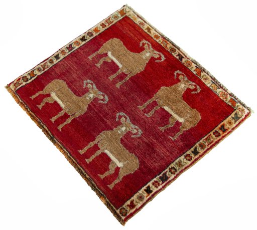 Corner detail of 2000s Persian Gabbeh rug showing border pattern and Wool pile