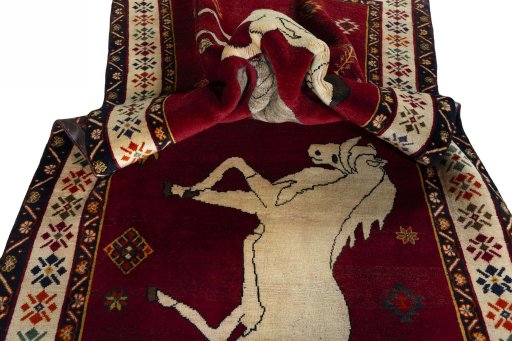 Corner detail of 2000s Persian Gabbeh rug showing border pattern and Wool pile