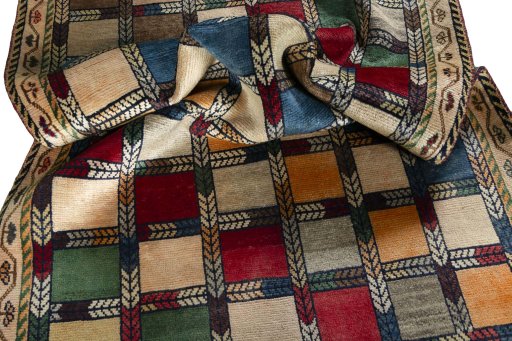 Corner detail of 2000s Persian Gabbeh rug showing border pattern and Wool pile